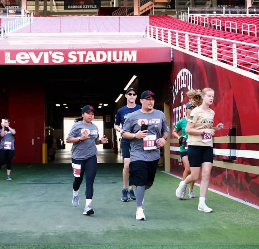 Runners enter the Levi's Stadium field through a team entrance.