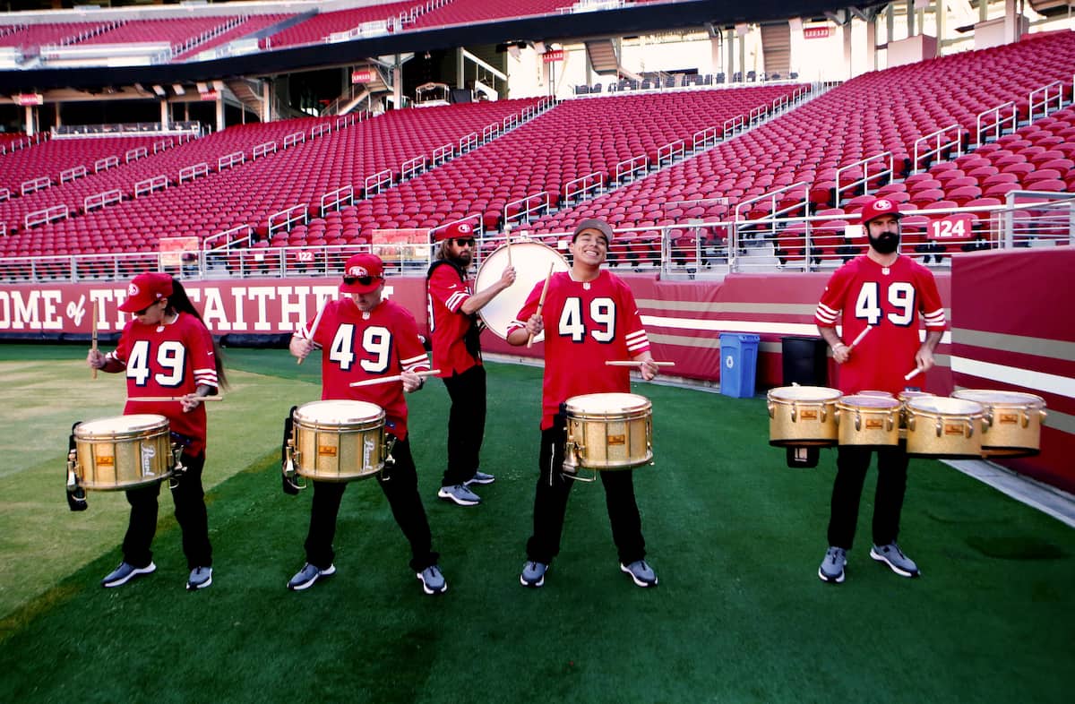 A small drum core in 49ers jerseys play to encourage the race participants.