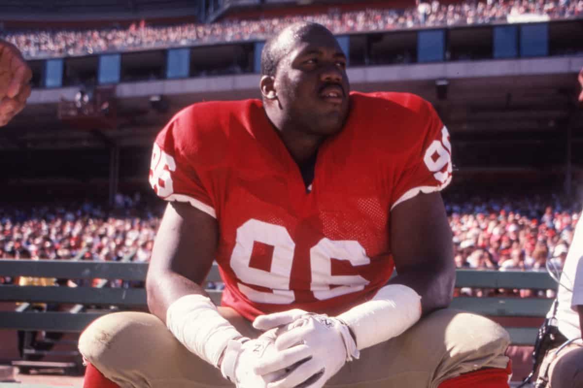 49ers alumnus Dennis Brown sits on the sideline pensively, awaiting his opportunity to take the field.