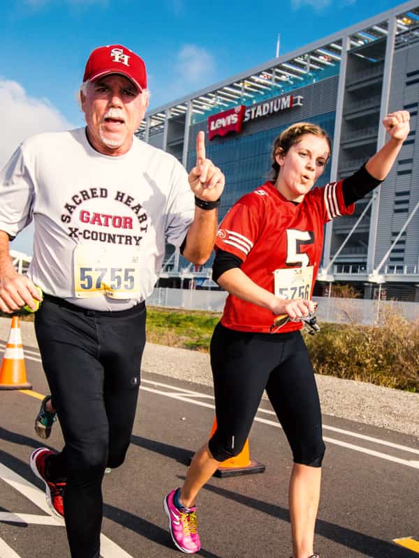 A father and daughter keep pace side-by-side in the middle stretch of the marathon.