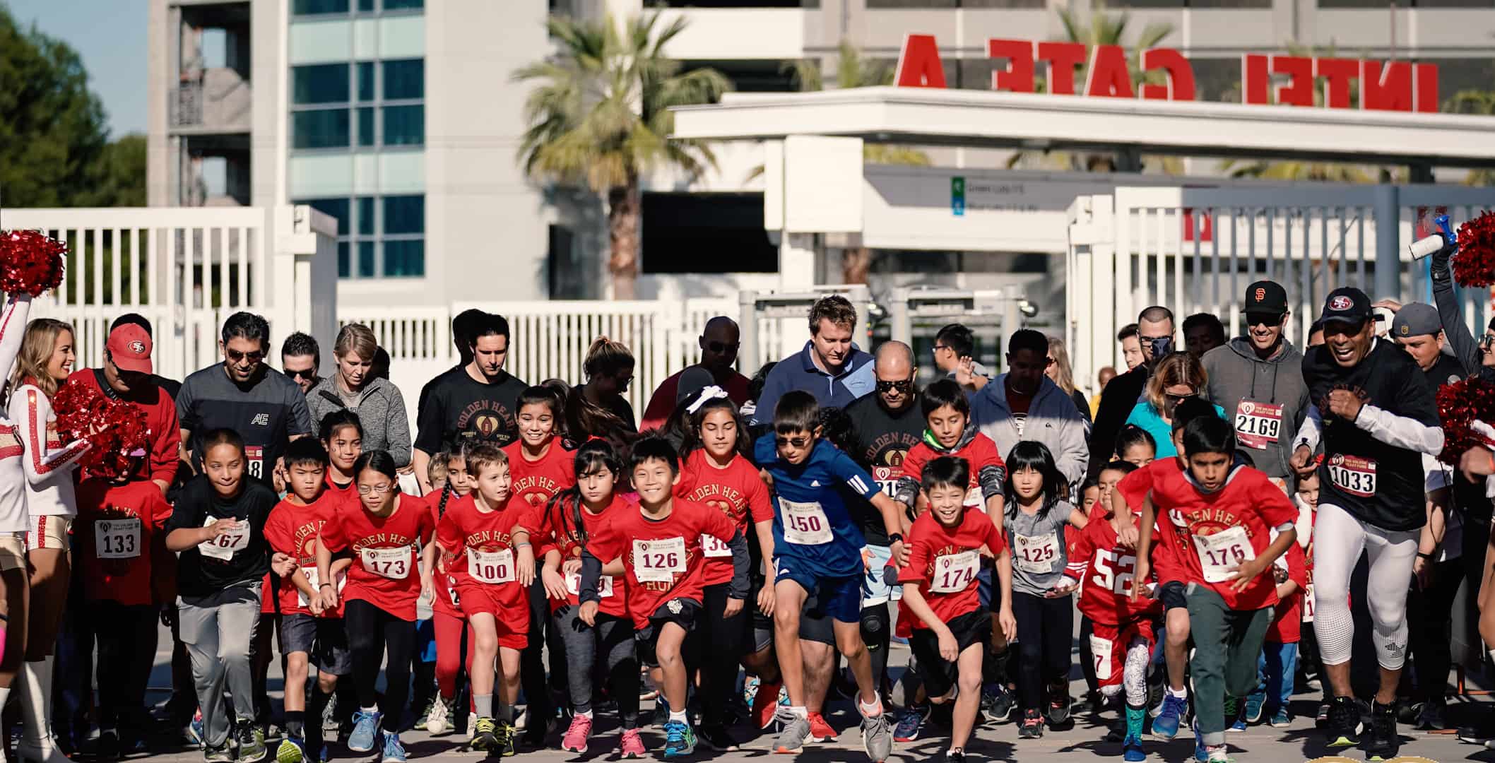 A large group of children depart the starting line of the 2019 marathon.